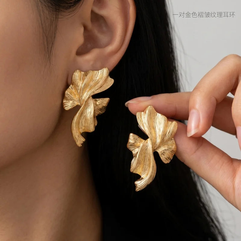 Obega Gold Abstract Wave Earrings — Textured Leaf Statement Studs
