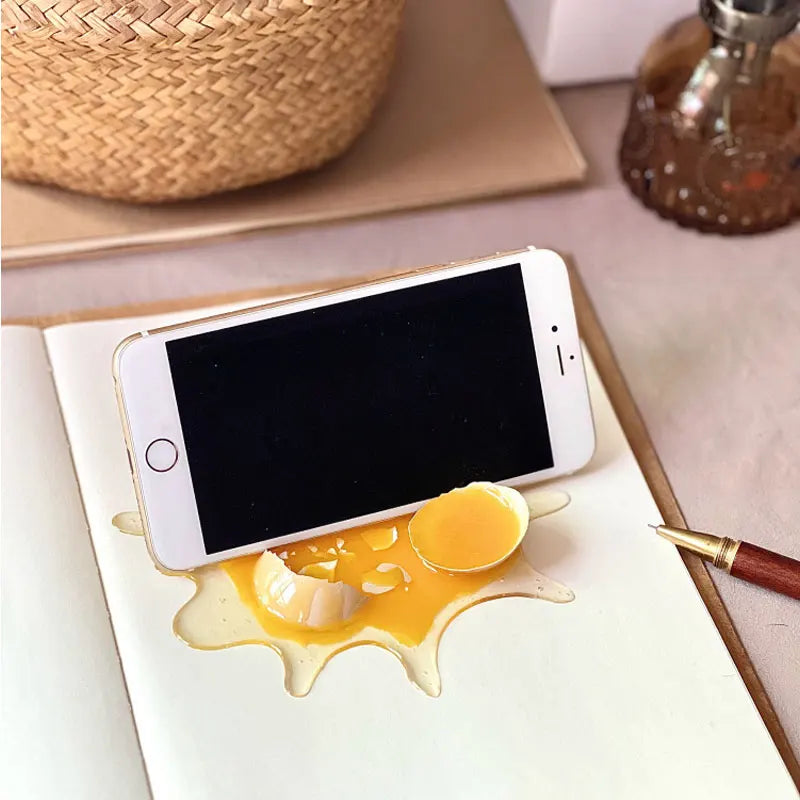 MYGVN Realistic Broken Egg Prank Toy — Funny Mobile Phone Holder & Gag Gift